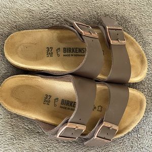 Brown leather Birkenstock sandals.